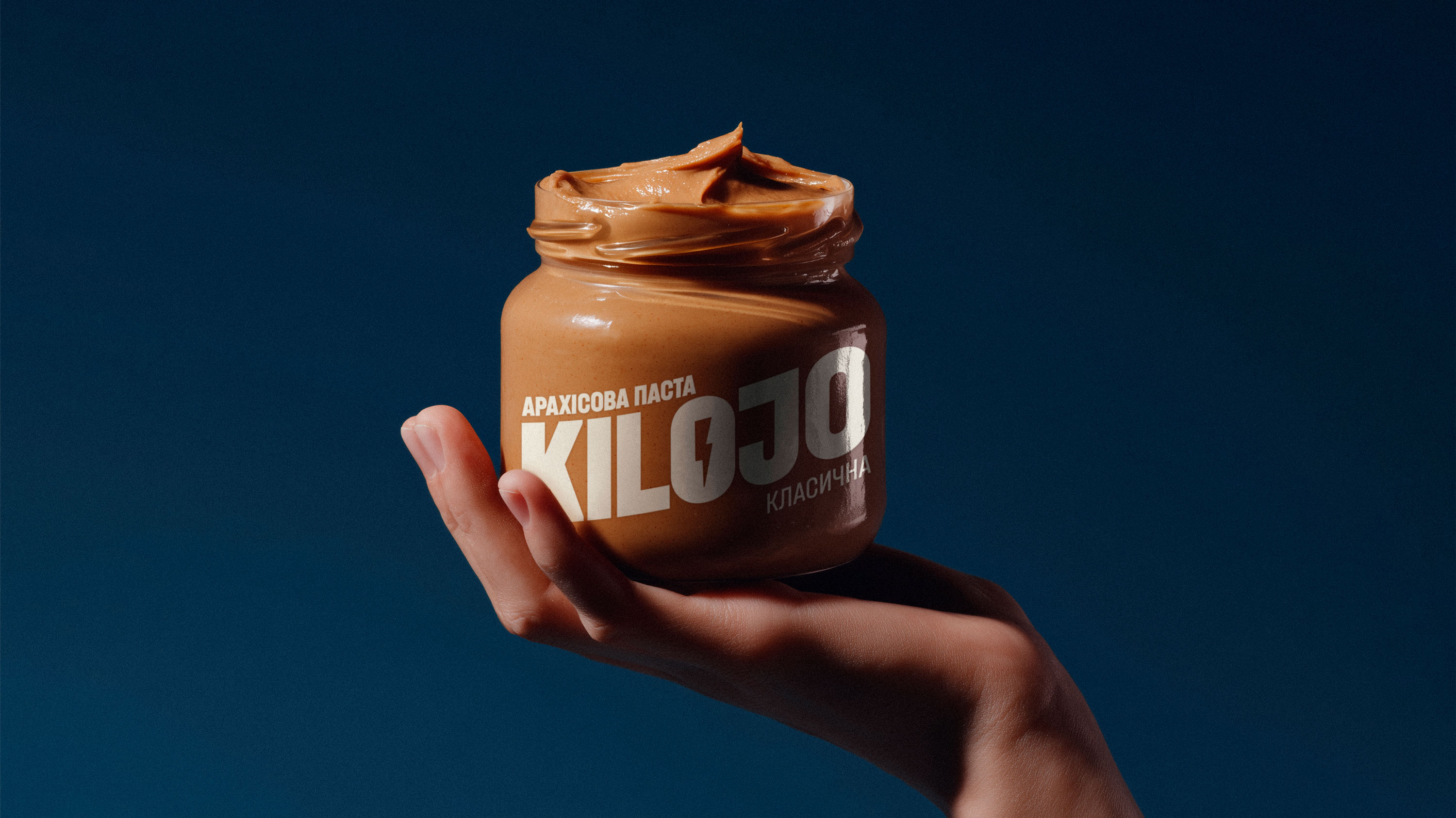 u7295234929_Hyperrealistic_mockup_of_nut_butter_paste_jar_held__8b52f150-bf89-4f12-8b04-b486b0f2dfeb.jpg